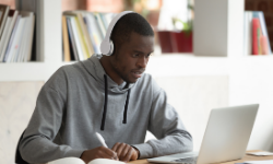 Image of male student working on his laptop.