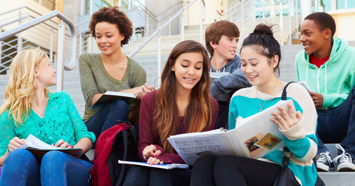 Students sitting on campus steps studying