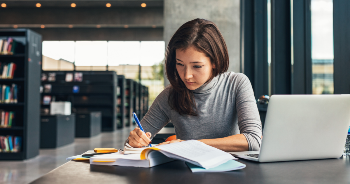 Picture of female student studying in library 