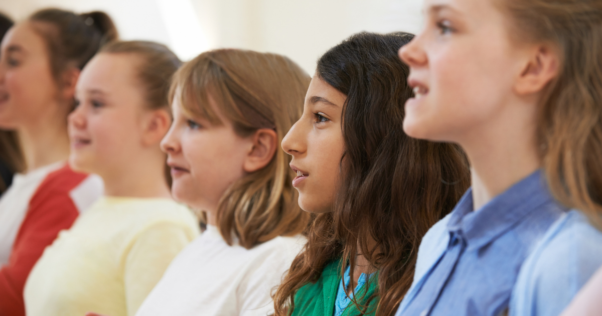 Middle school aged students standing in a line