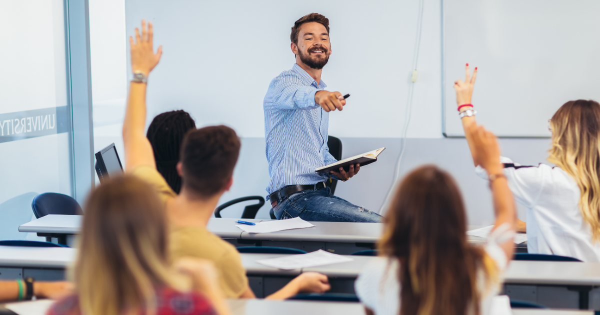 Teacher pointing at student with raised hand