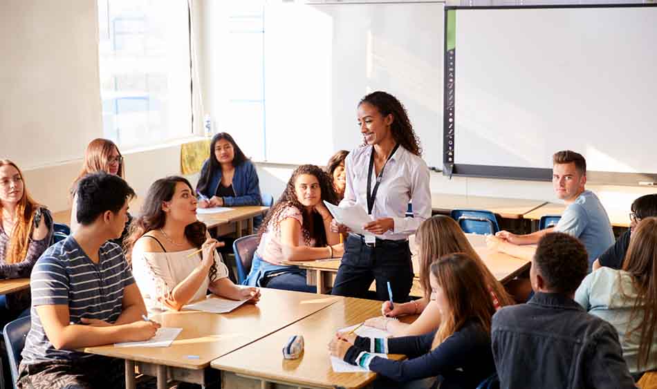 Teacher speaking to classroom full of students