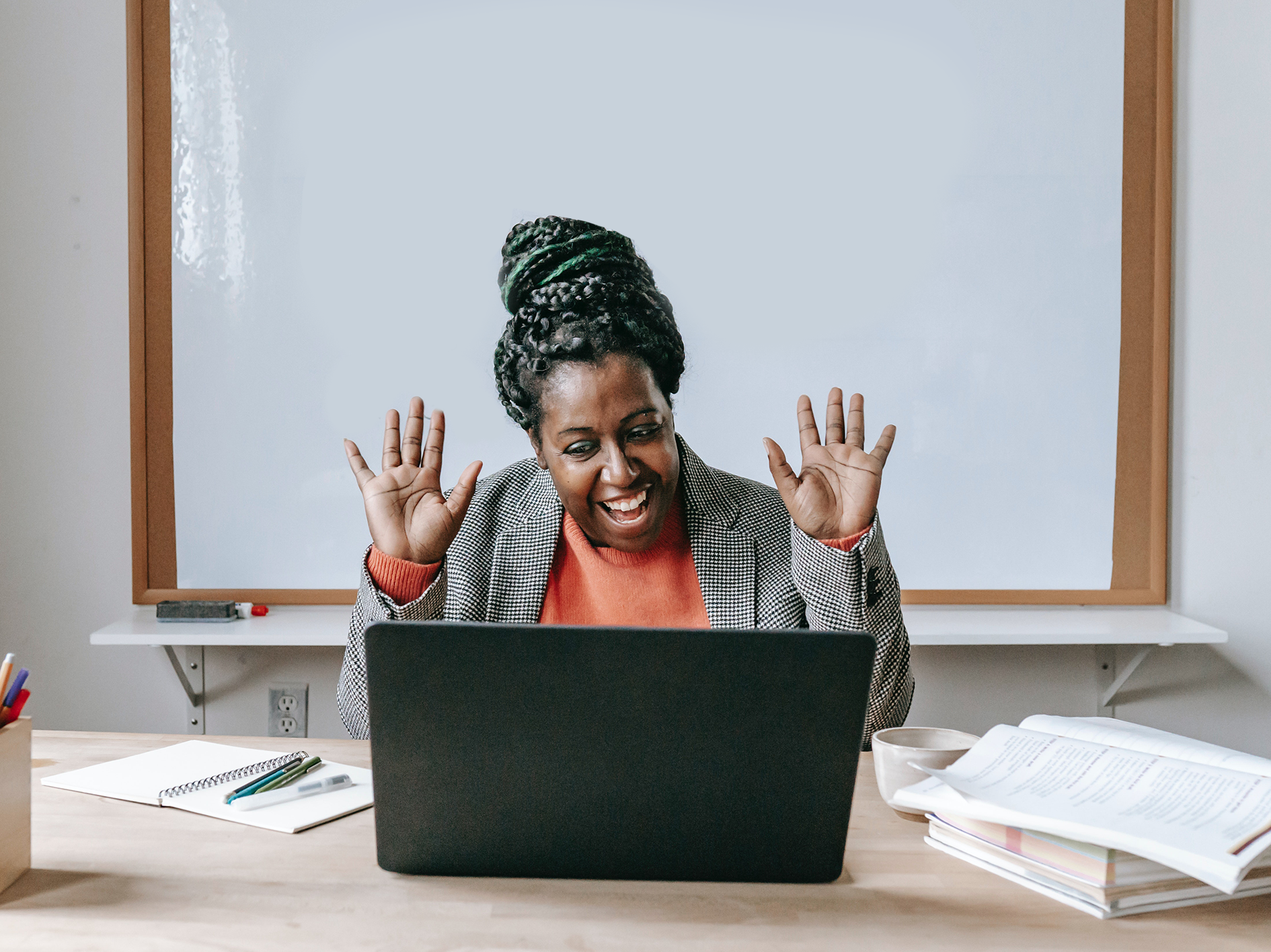 Teacher smiles at laptop 