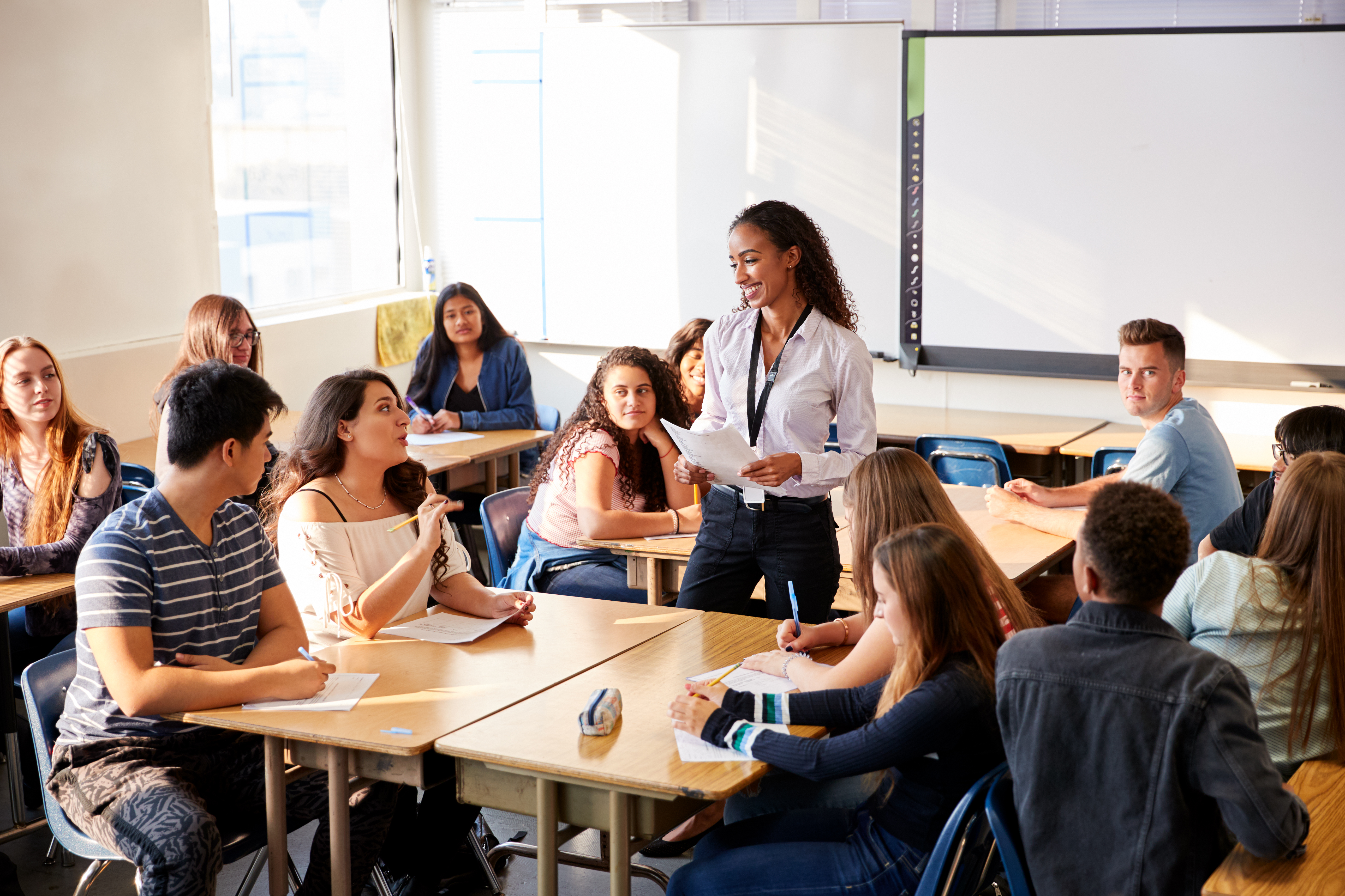 Teacher speaking to classroom full of students